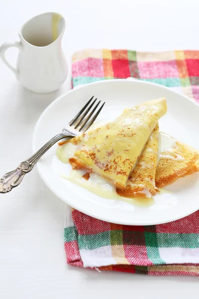 Pancakes with condensed milk — Stock Photo, Image