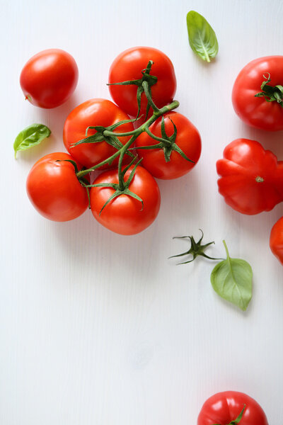 red tomatos branch on white boards