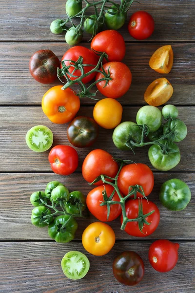 Set of tomatoes on wooden boards — Stock Photo, Image