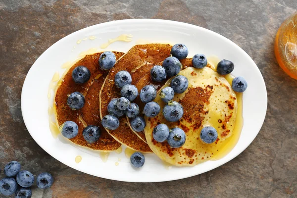 Hot golden pancakes with berry on plate — Stock Photo, Image