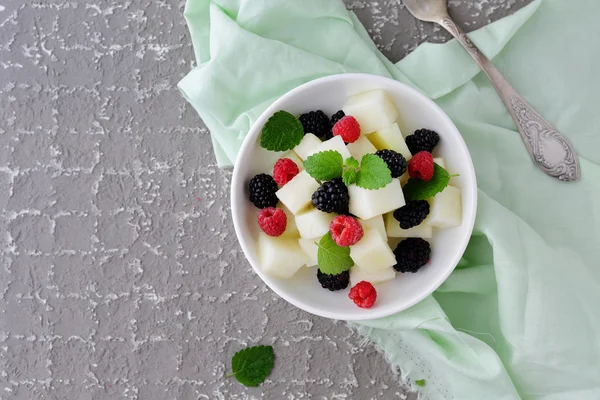 Salad with melon and berries in bowl — Stock Photo, Image