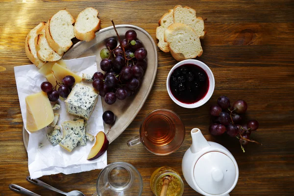 Tea with cheese and jam on table — Stock Photo, Image