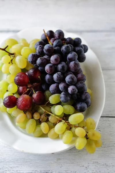 Mix grapes on white plate — Stock Photo, Image