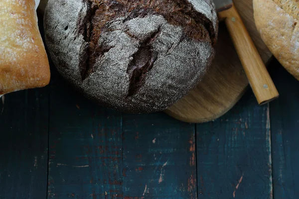 Loafs rustic bread on wooden boards — Stock Photo, Image