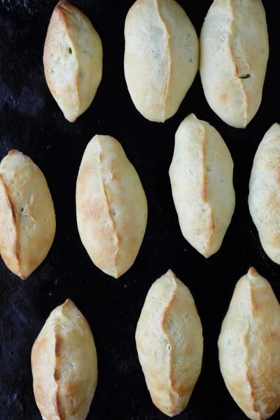 Small pastry pie on black tray — Stock Photo, Image