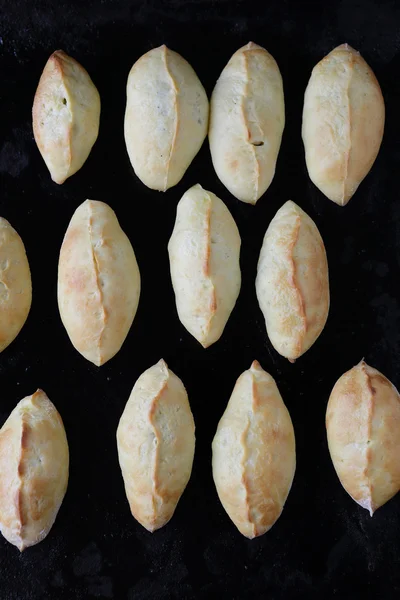 Fresh pastry pie on black tray — Stock Photo, Image