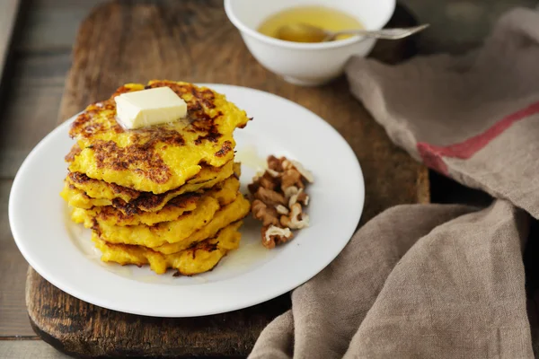 Sweet pumpkin pancakes with butter — Stock Photo, Image