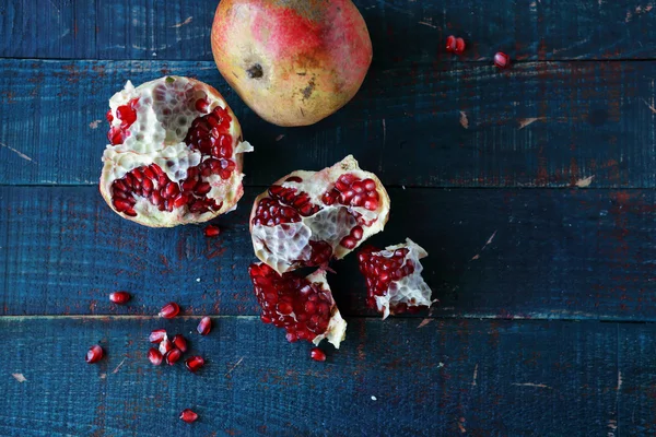 Sweet open pomegranate on boards — Stock Photo, Image