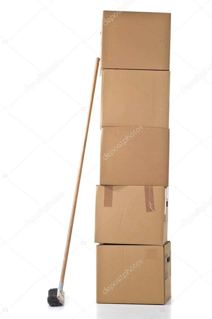 Moving carton boxes stack with broom