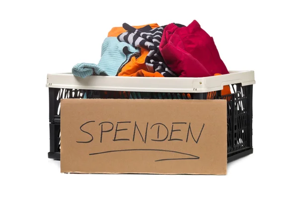Plastic box with clothing donations and cardboard sign — Stock Photo, Image