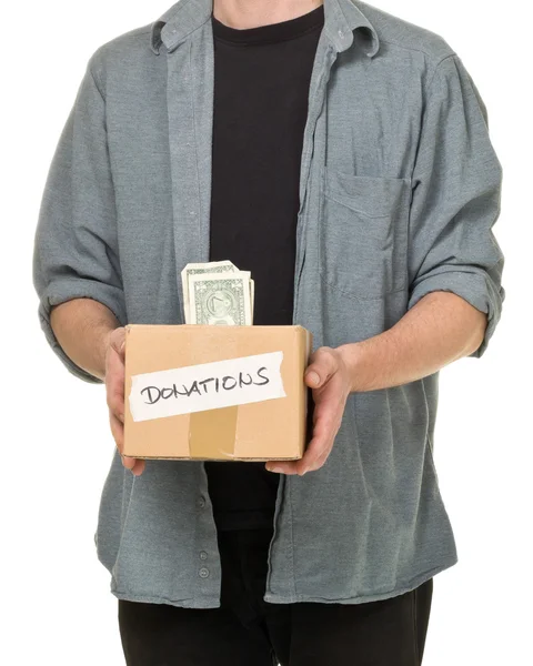 Homem segurando caixa de papelão de doação com notas de dólar — Fotografia de Stock