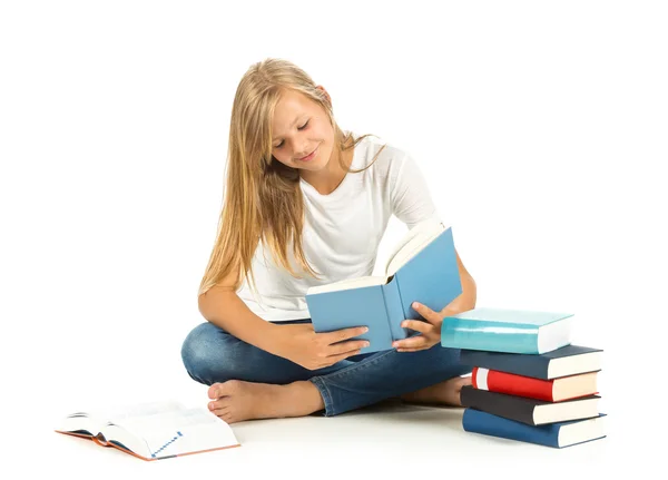 Young girl sitting on the floor reading over white background — Stock Photo, Image