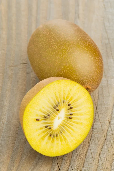 Golden kiwifruit cut and whole — Stock Photo, Image