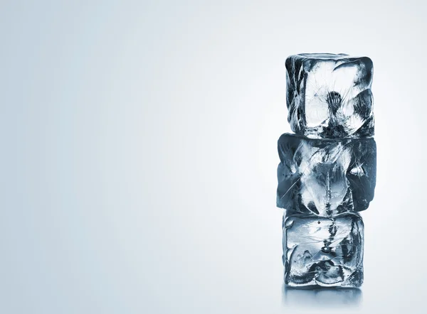 Stack of three blue ice cubes with copyspace — Stock Photo, Image