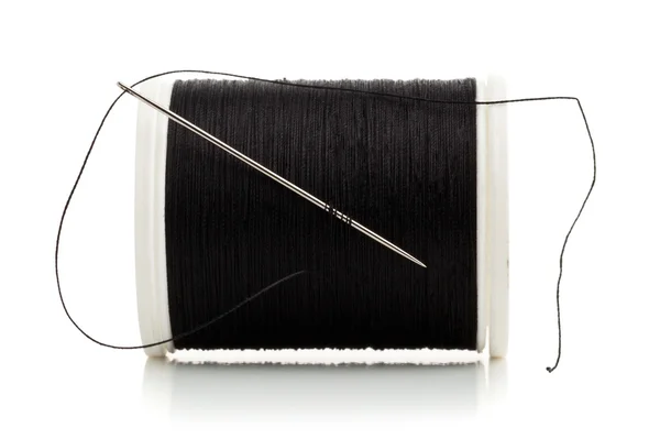 Sewing needle and thread spool macro — Stock Photo, Image