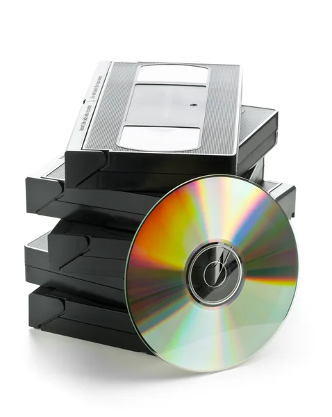 Stack of analog video cassettes with DVD disc — Stock Photo, Image