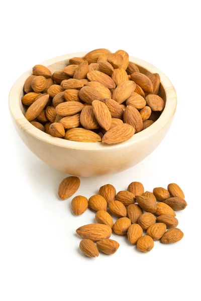 Cracked and shelled almond kernels in wooden bowl — Stock Photo, Image