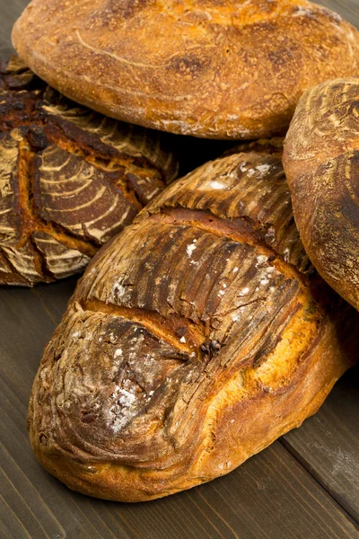 Hand made bread loaves on wooden table — Stock Photo, Image