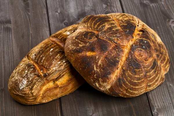 Hand made bread loaves on wooden table — Stock Photo, Image