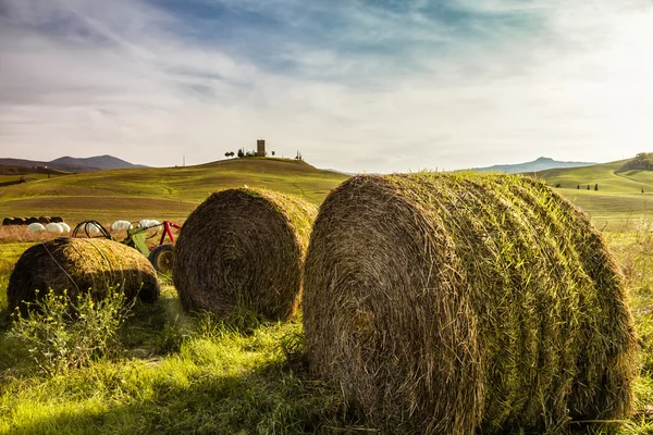 Bales of hay on a farm at sunset in Tuscany (Italy) Stock Image