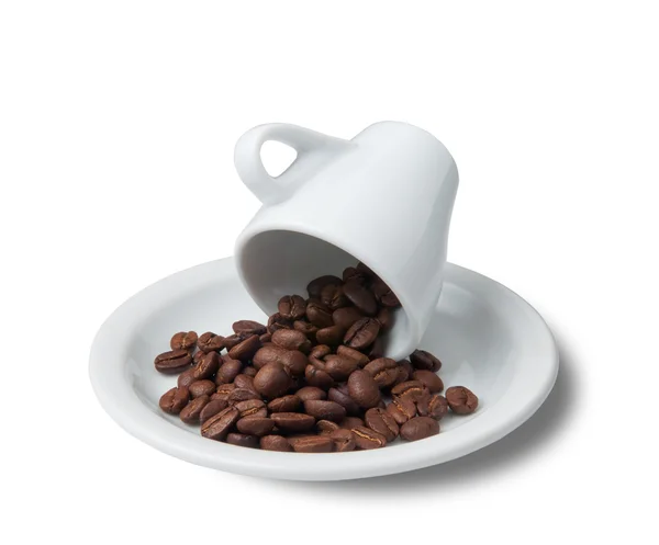 Little cup with scattered coffee beans lying on saucer — Stock Photo, Image