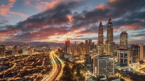 Kuala Lumpur 'un üzerinde, Malezya' nın milli simgesi olan Petronas Kuleleri 'ne bakan alevli bir gün doğumu.