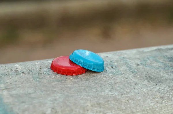 Two Colored Bottle Caps Wall Focus Foreground — Stock Photo, Image