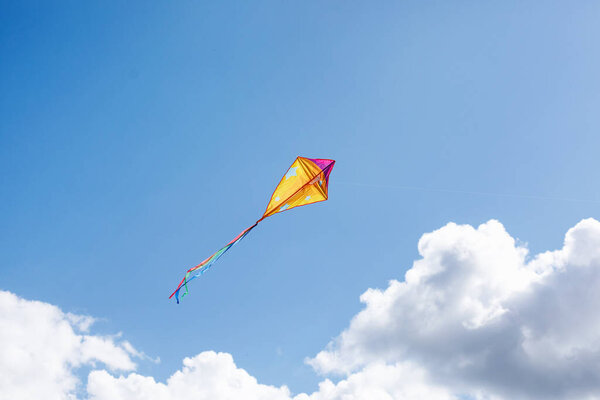 A multicolored kite soars in the sky