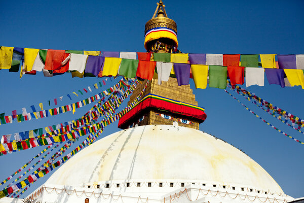 Buddhist Tibetan prayer flags lungta and World's Largest stupa in Nepal