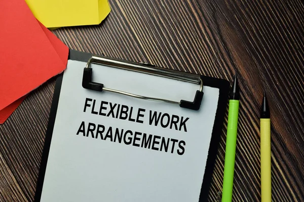 Flexible Work Arrangements write on a paperwork isolated on wooden background.