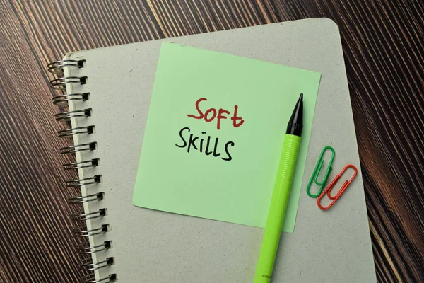 Soft Skills write on sticky note isolated on Wooden Table. Business Concept