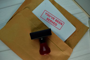 Red Handle Rubber Stamper and You've Been Served text isolated on the table. clipart