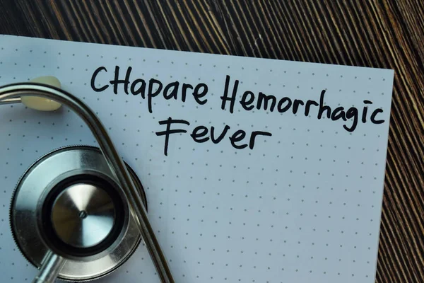 Chapare Hemorrhagic Fever write on a book isolated on Wooden Table. Medical or Healthcare concept