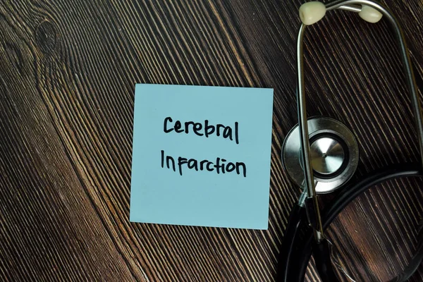 Cerebral Infarction write on sticky notes isolated on Wooden Table. Medical or Healthcare concept