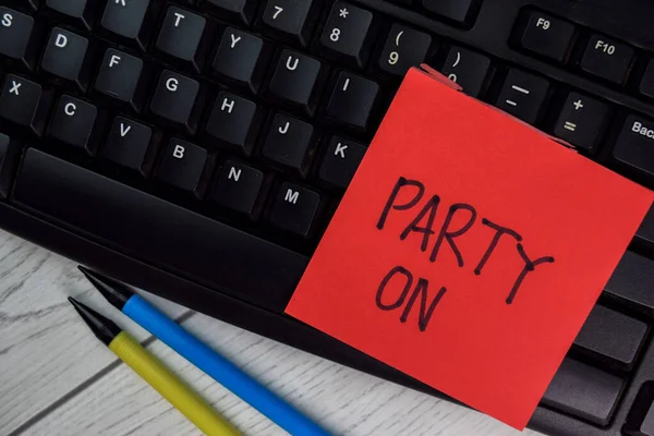 Party ON write on sticky notes isolated on Wooden Table.