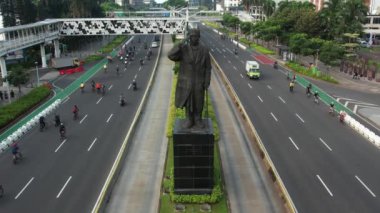 Anayolda bisiklet süren bisikletli grubun hava görüntüsü. Dron manzaralı bisiklet kırsal yolda araba yolunda. JAKARTA - Endonezya. 21 Mayıs 2021 