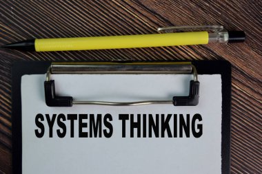 Sistemler Tahta Masa 'da izole edilmiş bir kağıt üzerine yazmayı düşünüyor.