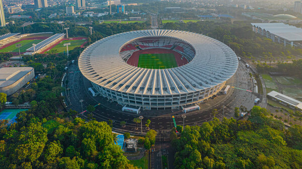 Aerial top down view of the Beautiful scenery of Senayan Stadium. with Jakarta cityscape background. Jakarta, Indonesia, August 3, 2021