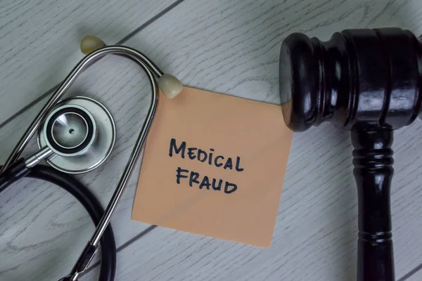 Medical Fraud Write Sticky Notes Isolated Wooden Table — Stock Photo, Image