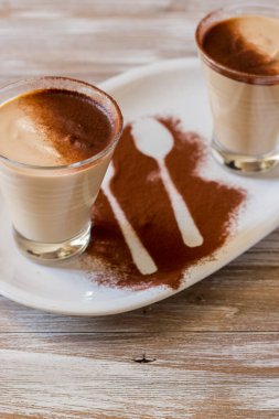 coffee ricotta, spoon dessert in glass cup served in a white plate