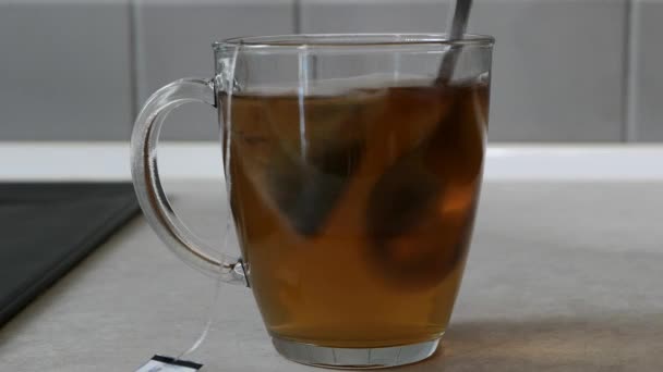 Sachet Thé Mélangé Avec Une Cuillère Dans Une Tasse Transparente — Video