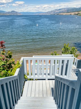 Big lake overview with wooden stairway to the beach on the shore