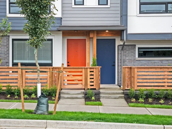 Red and blue doors of brand new residential townhouses — Stock Fotó