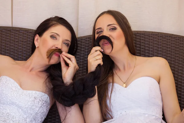 Funny brides making mustache — Stock Photo, Image