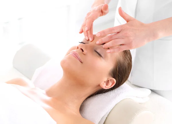 Beautician beautiful woman massaging her temples — Stock Photo, Image