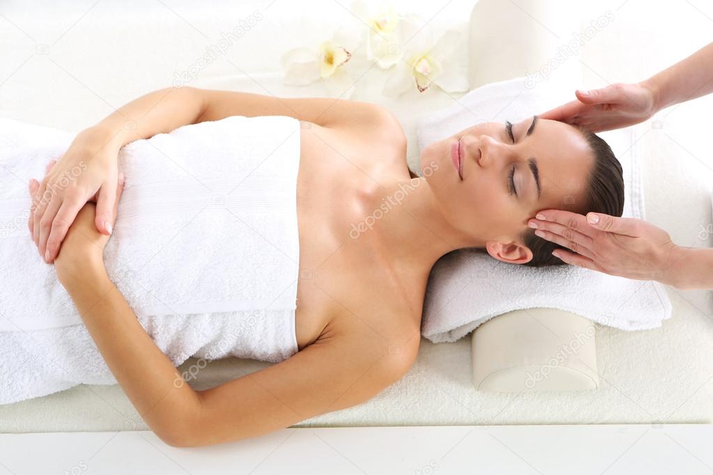 Massage temples . Beautiful woman in spa salon