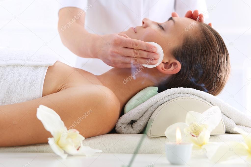 Cleansing facial skin, a woman in beauty salon