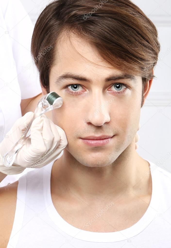 Attractive man in a beauty salon, micro needle mesotherapy treatment