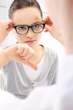 Vision test, a child an ophthalmologist. clipart