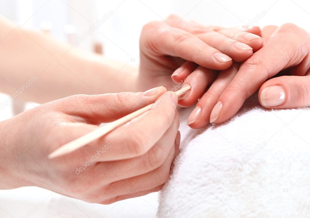 Woman to a beautician for a manicure